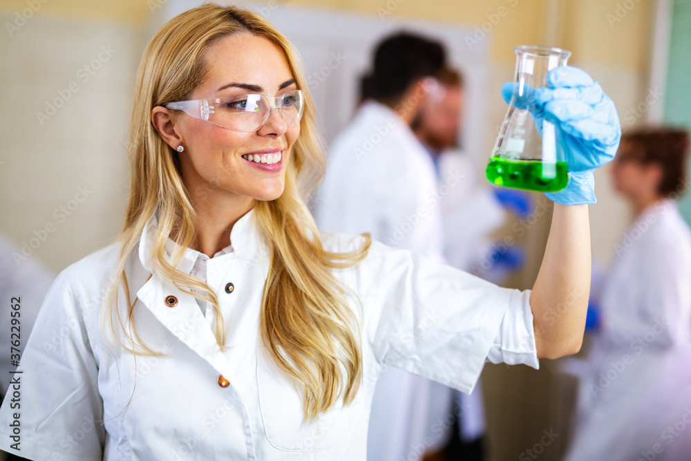 Woman student, scientist of chemistry working in laboratory