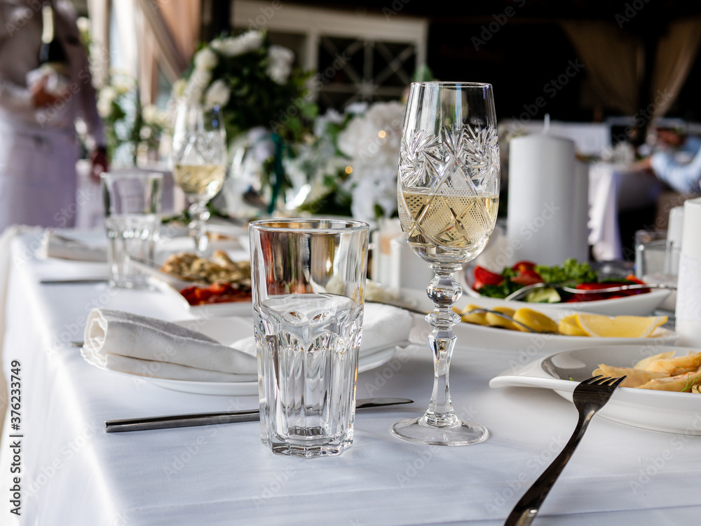 Set table in the restaurant. Empty glasses on the table in the restaurant waiting for guests.