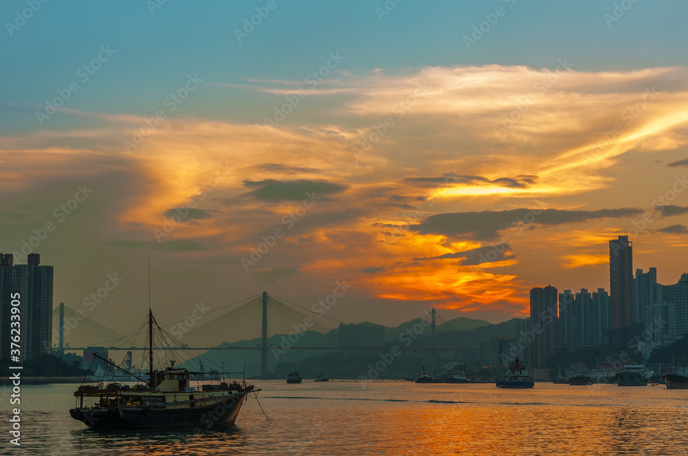 harbor and skyline of Hong Kong city under sunset