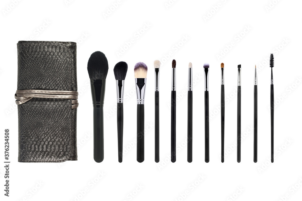 Leather case for cosmetics and professional makeup brushes in different sizes. set of makeup brushes isolated on white background. Top view. Leather case for cosmetics and professional makeup brushes in different sizes. set of makeup brushes isolated on white background. Top view.