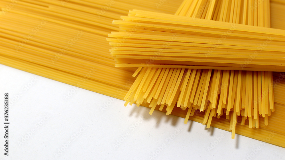 Yellow long spaghetti on white background Yellow long spaghetti on white background