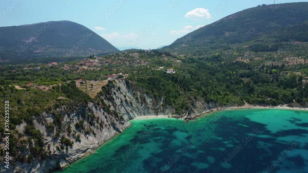 Aerial drone video of tropical paradise island covered in pine trees with turquoise crystal clear beach in Mediterranean destination Aerial drone video of tropical paradise island covered in pine trees with turquoise crystal clear beach in Mediterranean destination