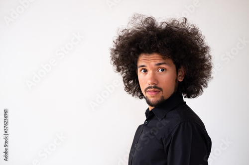 Latin american model with curly hair,cute expression,  neutral background  © Inga Pracute 