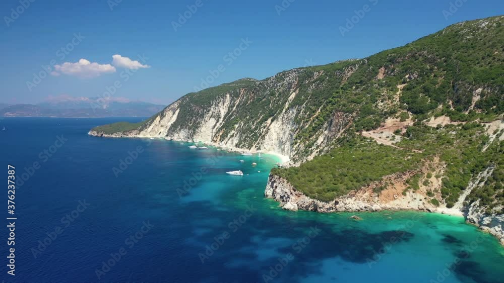 Aerial drone video of tropical paradise island covered in pine trees with turquoise crystal clear beach in Mediterranean destination Aerial drone video of tropical paradise island covered in pine trees with turquoise crystal clear beach in Mediterranean destination