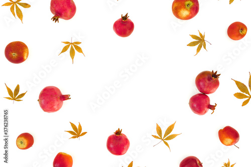 Fototapeta Naklejka Na Ścianę i Meble -  Pomegranate with apple and fall leaves isolated on white background. Flat lay
