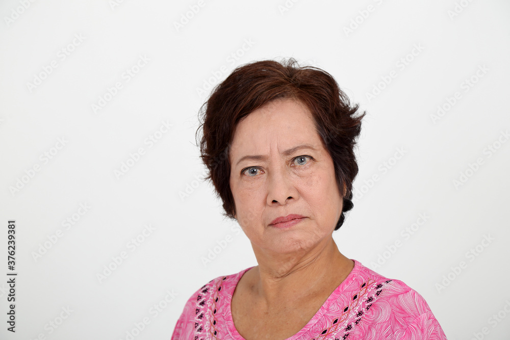 Elderly asian Chinese female on white background look at camera angry serious Elderly asian Chinese female on white background look at camera angry serious