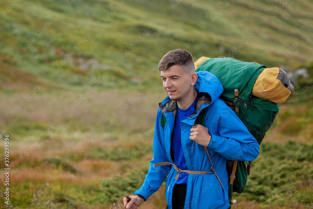 Naklejka premium Hiker on the top in Carpathians mountains. Travel sport lifestyle concept