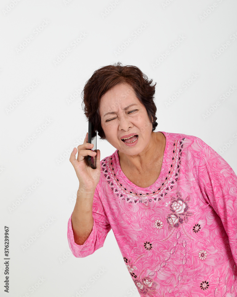 Elderly asian Chinese female on white background talking on phone can not hear face expression Elderly asian Chinese female on white background talking on phone can not hear face expression