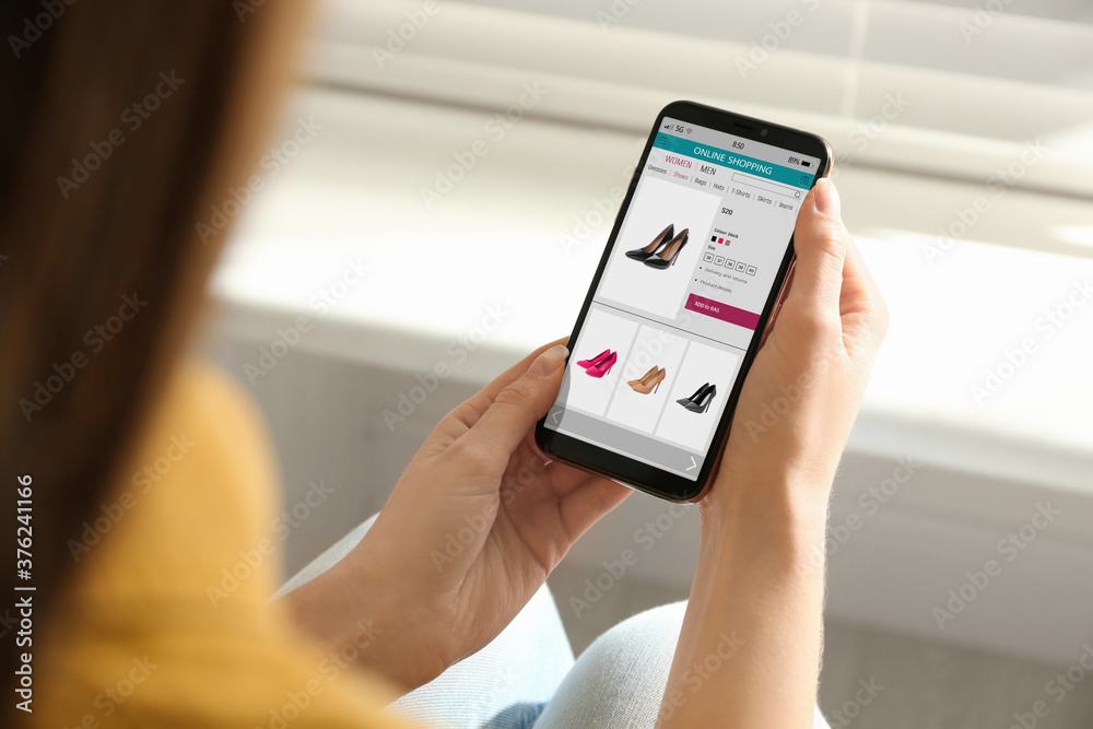 Woman shopping online via smartphone indoors, closeup Woman shopping online via smartphone indoors, closeup