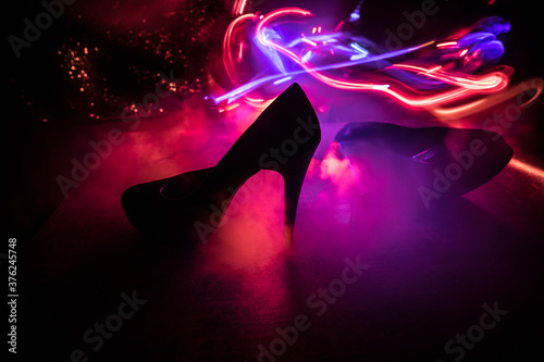 Silhouette of a high heel women shoes at dark. Women power or women domination concept.