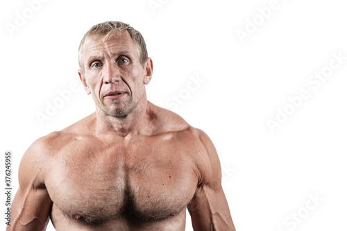 Close-up portrait of old brutal bodybuilder with serious face posing isolated on white background. Muscular adult male with naked torso