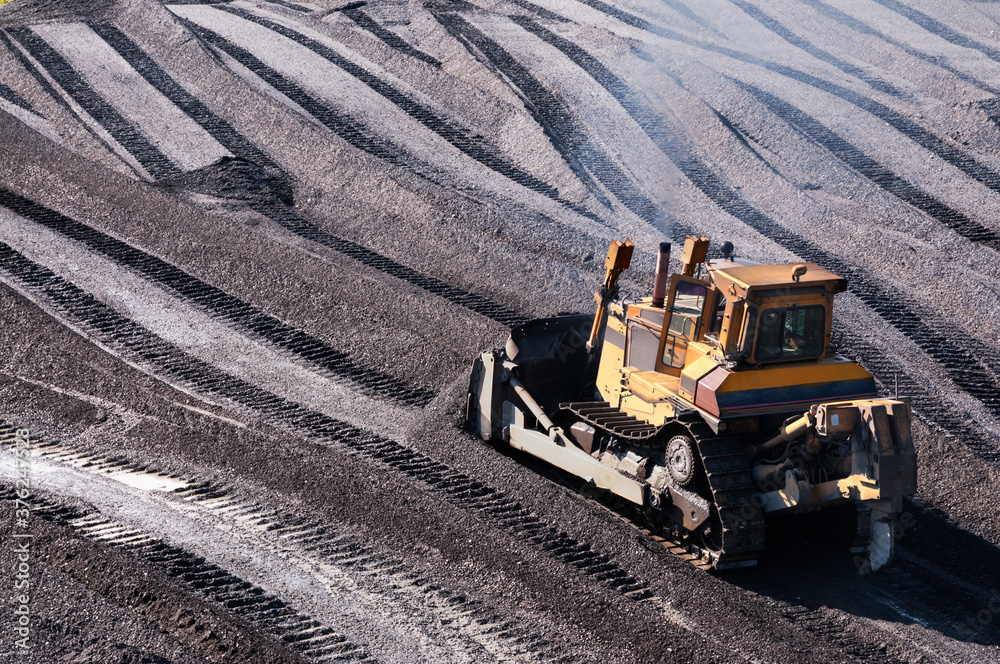 Bulldozers in mountainous wooded areas, layer by layer, remove mountain soil from the surface and shovel it to the side. Bulldozers in mountainous wooded areas, layer by layer, remove mountain soil from the surface and shovel it to the side.