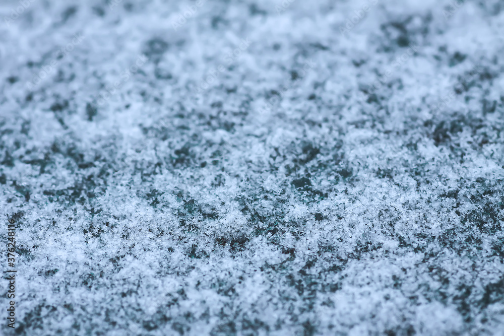 Snowflakes during the snowfall on glass surface Snowflakes during the snowfall on glass surface