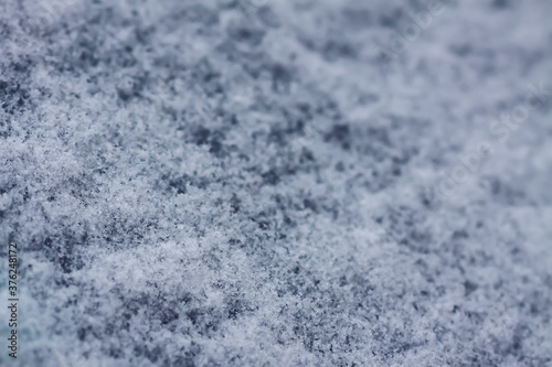 Snowflakes during the snowfall on glass surface