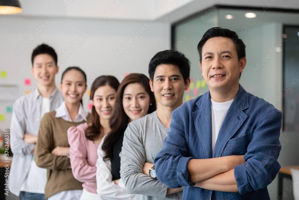 Group of Happy Asian business men leader standing smile cross arm confidence with Business team at Co-Working space,Small Business Startup Concept Group of Happy Asian business men leader standing smile cross arm confidence with Business team at Co-Working space,Small Business Startup Concept