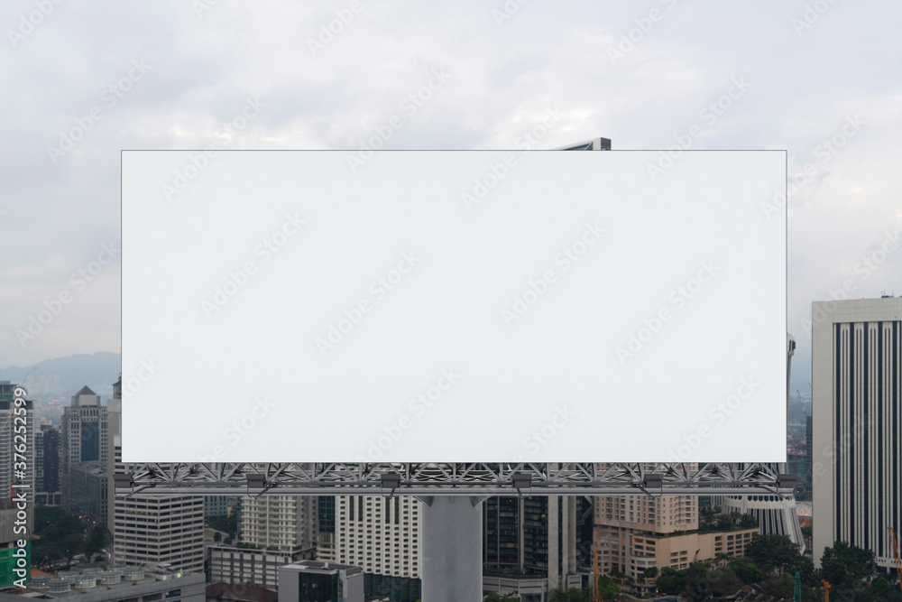 Blank white road billboard with KL cityscape background at day time. Street advertising poster, mock up, 3D rendering. Front view. The concept of marketing communication to promote or sell idea. Blank white road billboard with KL cityscape background at day time. Street advertising poster, mock up, 3D rendering. Front view. The concept of marketing communication to promote or sell idea.