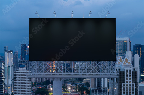 Photography Blank black road billboard with Kuala Lumpur cityscape background at night time