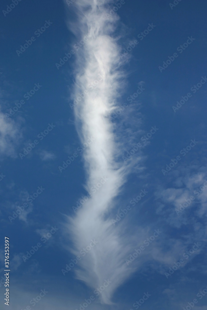 or a cloud or a plane track in the blue sky or a cloud or a plane track in the blue sky
