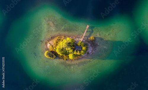 Aerial top down view of Lake Eibsee island with small hut and pier