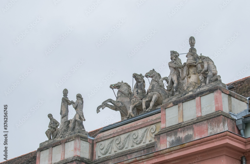 statue of horses on building roof