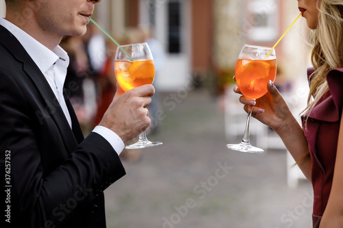 young couple drinking a cocktail.hands of two people holding cocktails. alcoholic cocktails. soft drinks