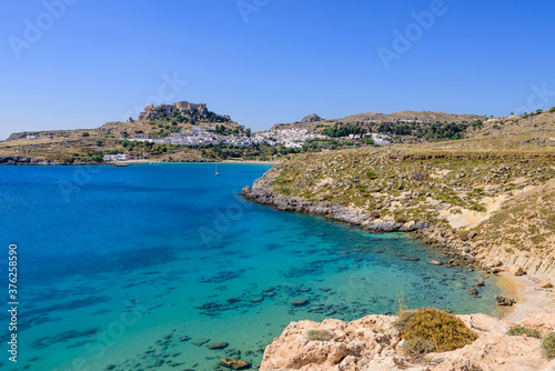 A picturesque Bay with blue water near the village of Lindos, Rhodes island, Dodecanese, Greece.