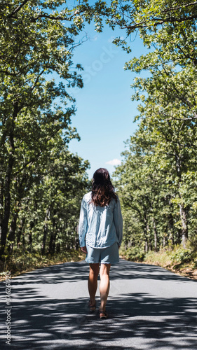 Young woman walking down a road