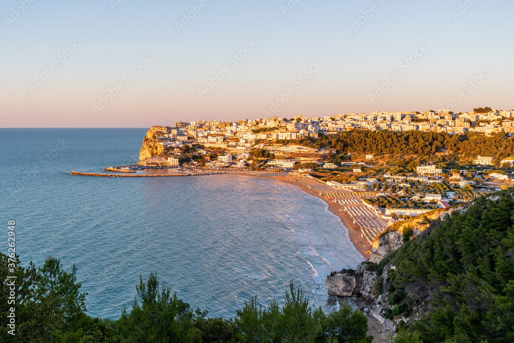 Aerial View of Peschici at sunset, Small picturesque village in province of Foggia, Gargano, Puglia, Italy