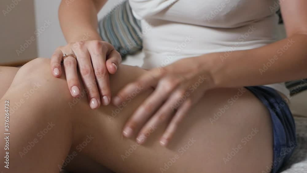 Woman rubs uses moisturizer and nourishing cream, oil for dry skin of feet Woman rubs uses moisturizer and nourishing cream, oil for dry skin of feet
