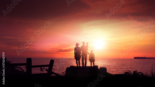 Fotografi Silhouette of a family on a background of red sunset.