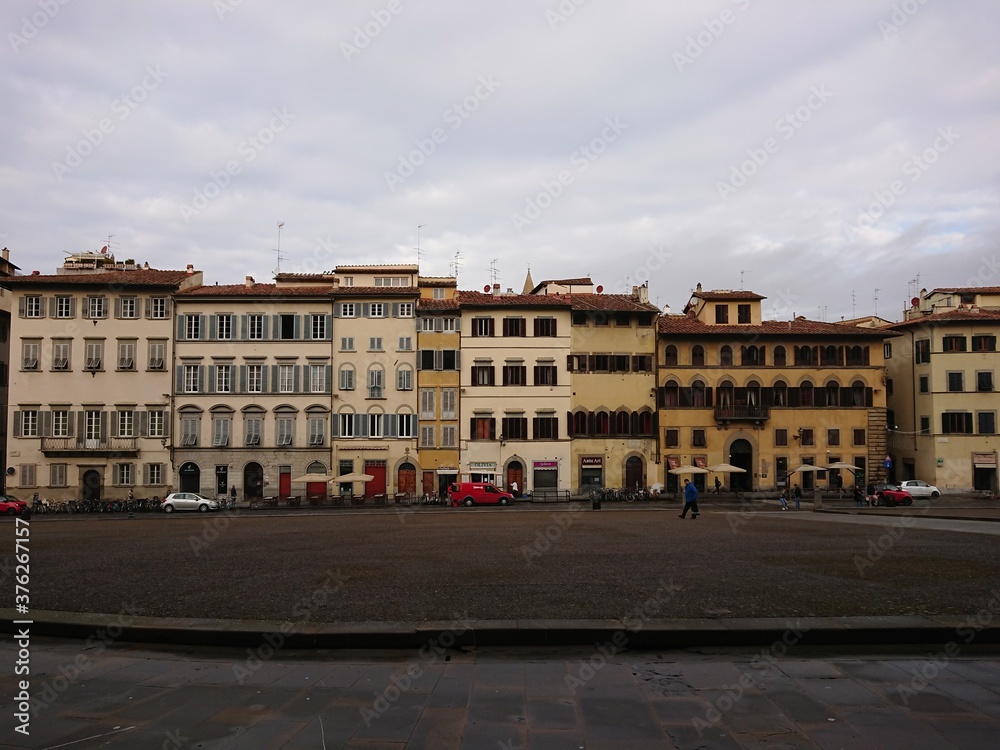 Obraz premium Row of Italian shop houses with variety of facades by the street
