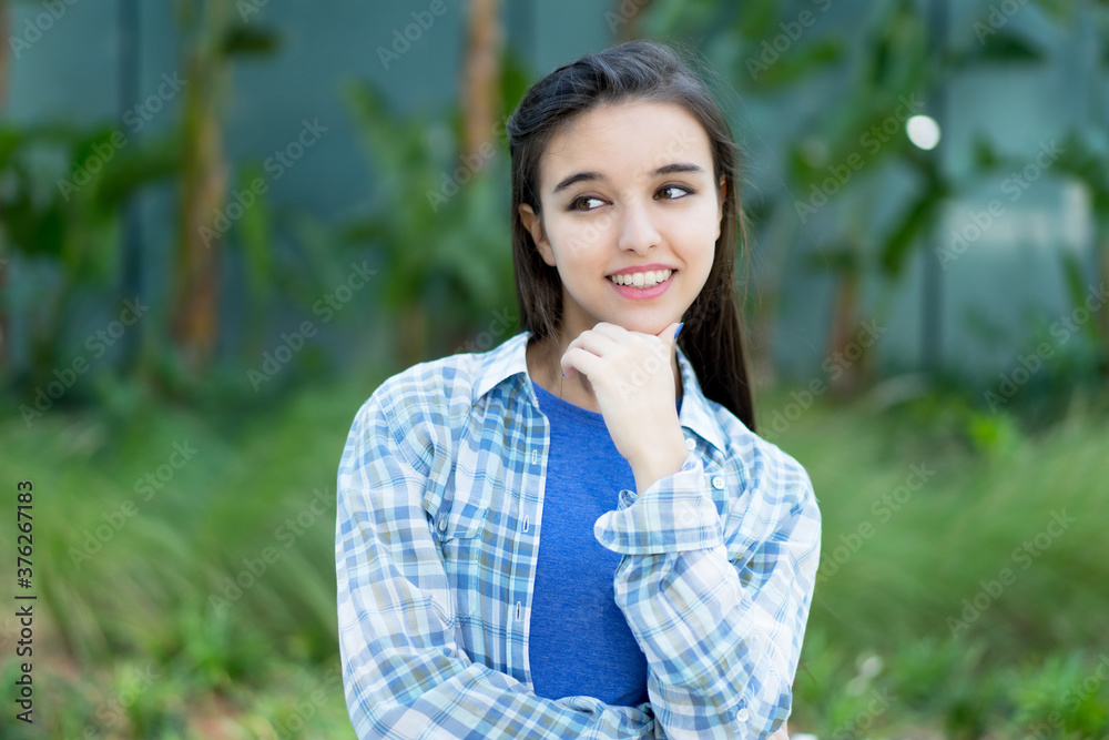 Laughing italian young adult woman with casual clothes