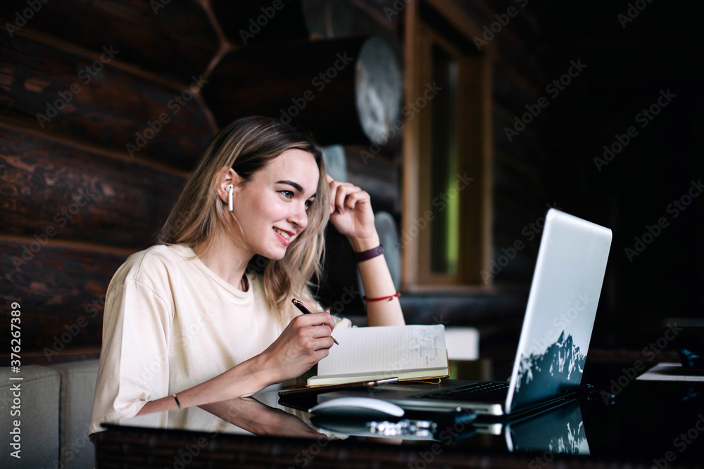 Young slender girl at the restaurant table works behind a laptop Young slender girl at the restaurant table works behind a laptop