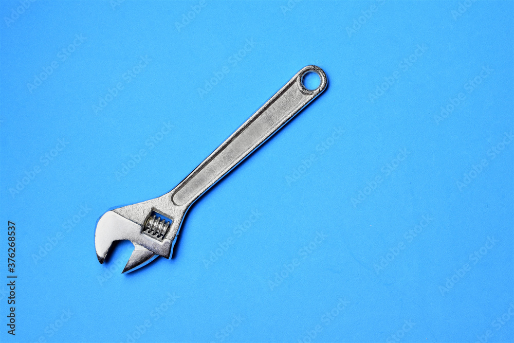 Variable wrench on blue background, space for text Variable wrench on blue background, space for text