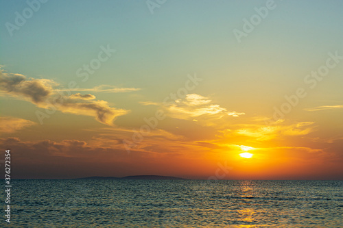Summer sunset over the blue sea