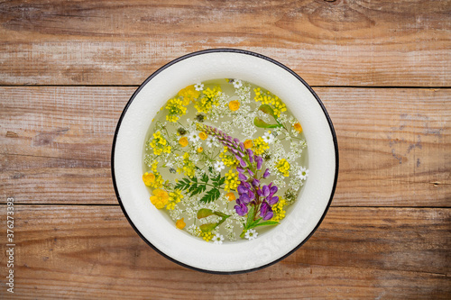 Floating wildflowers and herbs in a washbowl