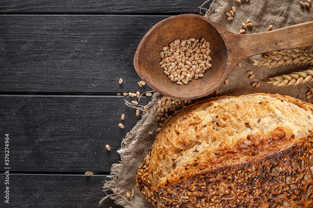 Fototapeta premium Assortment of baked bread on wooden table background