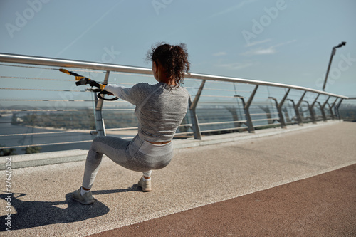 Fototapeta Naklejka Na Ścianę i Meble -  happy healthy and sporty woman is doing workout trainings in sunny day