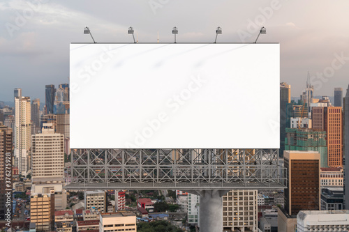 Canvas Print Blank white road billboard with Kuala Lumpur cityscape background at sunset