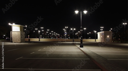 Empty outdoor contemporary Moscow car Parking with streetlights in family children's Park Island of Dreams on Andropova avenue on a summer night
