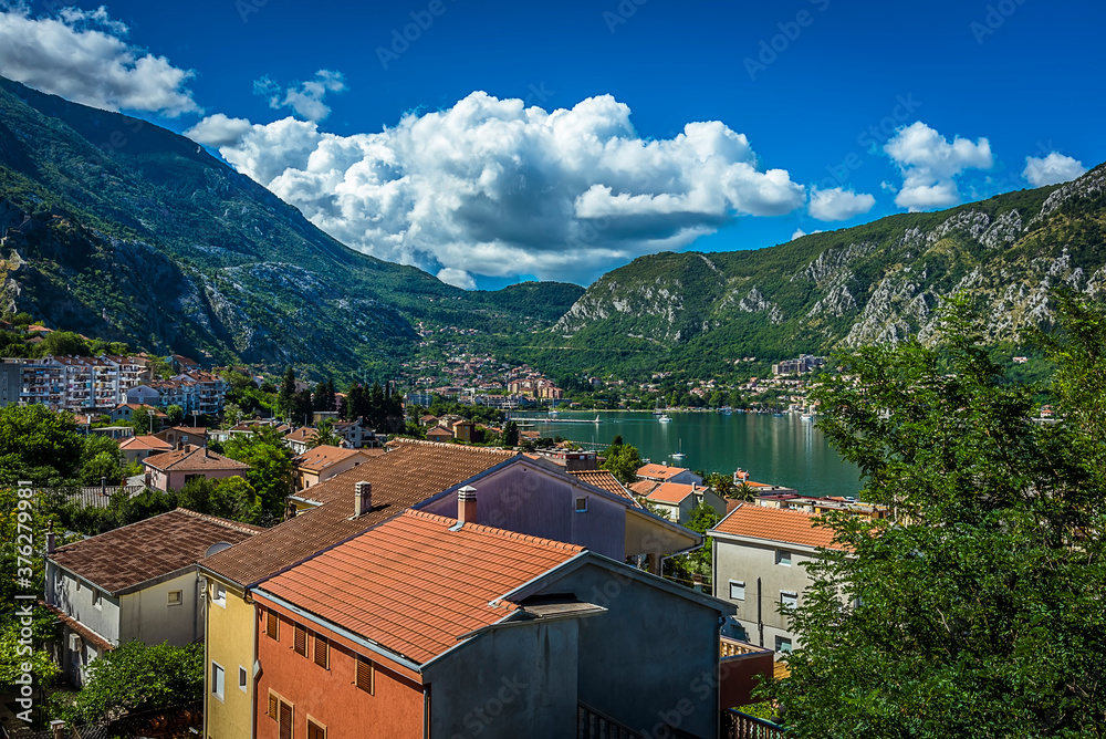 View across the roofs of the old town in Kotor (Stari Grad) to bay of Kotor fjord, in summer