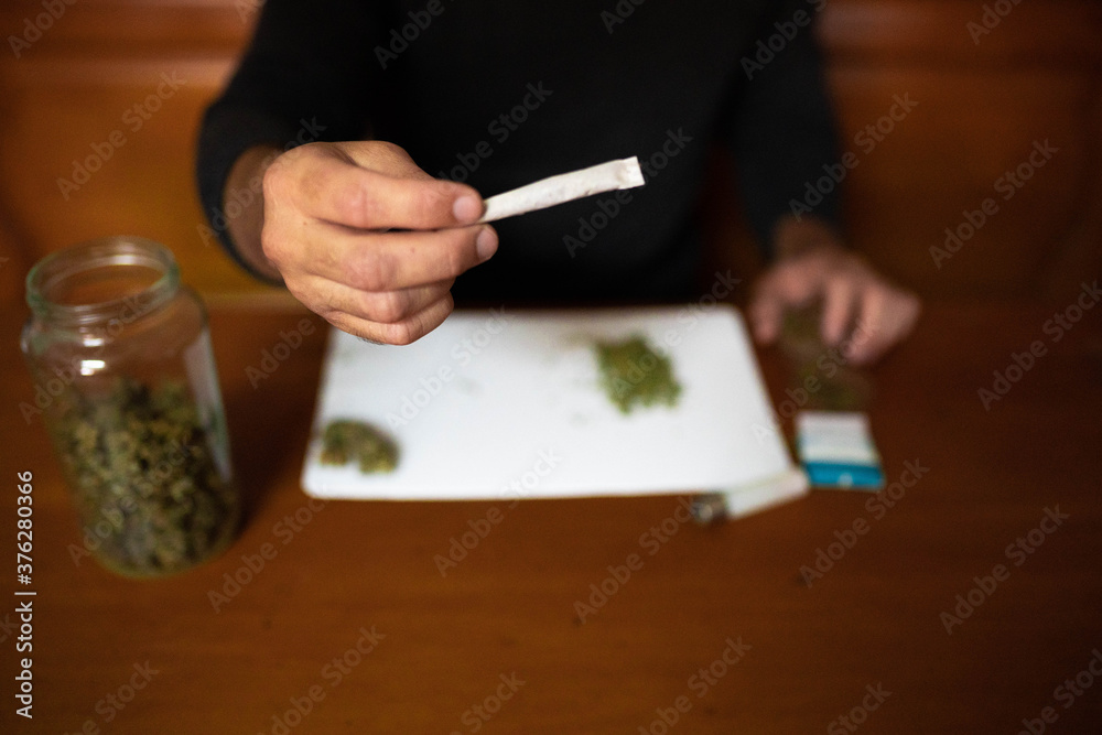 Wall Mural Preparing a joint and drug paraphernalia concept theme with herb girder used to