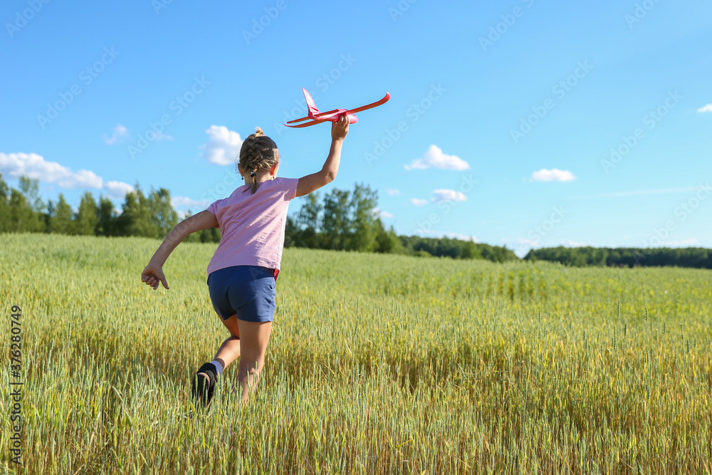 cheerful child plays with styrofoam plane in the summer field cheerful child plays with styrofoam plane in the summer field