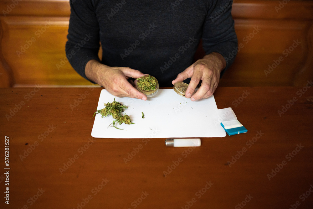 Preparing a joint and drug paraphernalia concept theme with herb girder