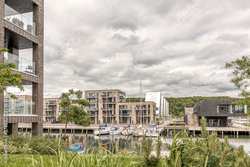 Obraz na płótnie Harbour marina with modern apartments and sailingboats in the canal w salonie
