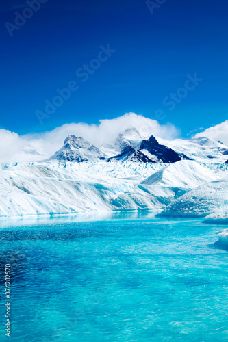 Lake on glacier with mountainous background.