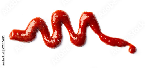 Red ketchup splash isolated on white background. Tomato Sauce abstract texture