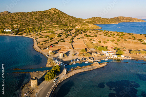 Aerial view of the crystal clear ocean and dry summer coastline of Kolokitha and Olous near Elounda, Crete, Greece photo
