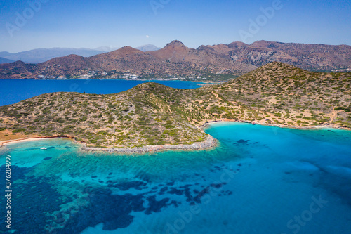 Fototapeta Naklejka Na Ścianę i Meble -  Aerial view of the rugged coastline of Crete and the clear waters of the Aegean Sea (Elounda, Greece)