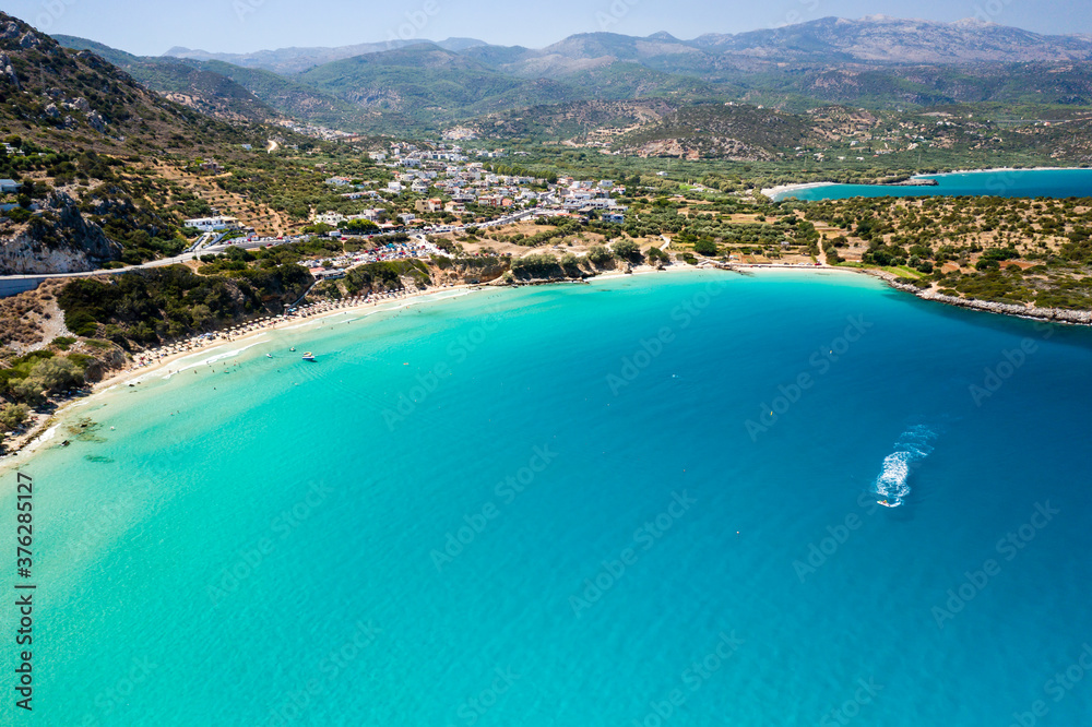 Aerial view of the beautiful sandy beach and crystal clear waters of Voulisma Beach, Crete, Greece
